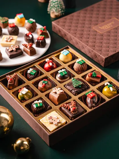 A luxurious box of my Christmas-themed Belgian chocolate pralines. Each chocolate is a miniature sculpture, from tiny presents to reindeer, making this a truly special and elegant gift.
