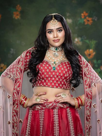 A powerful pose showing the rich colors and intricate details of the bridal outfit and jewelry.