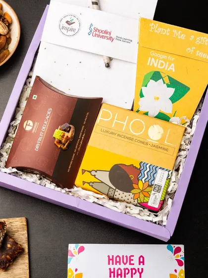 This eco-conscious hamper was created for a Google for India event in partnership with Shoolini University. It features a plantable seed paper note, Phool incense cones, and dry fruit delicacies, reflecting a commitment to sustainability.