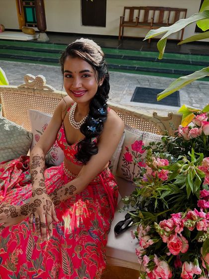 A client looking radiant with her modern, minimalist floral mehndi, perfect for a chic and sunny daytime event.