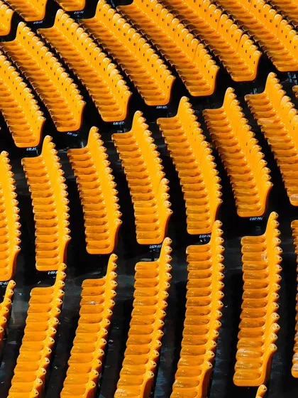 The vibrant yellow seats of the stadium in Gwalior, captured before the crowds arrive. These shots help set the scene for the event.