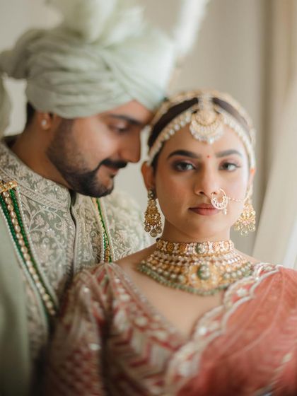 An intimate close-up that feels both artistic and emotional. The soft focus and gentle embrace highlight the couple's connection.