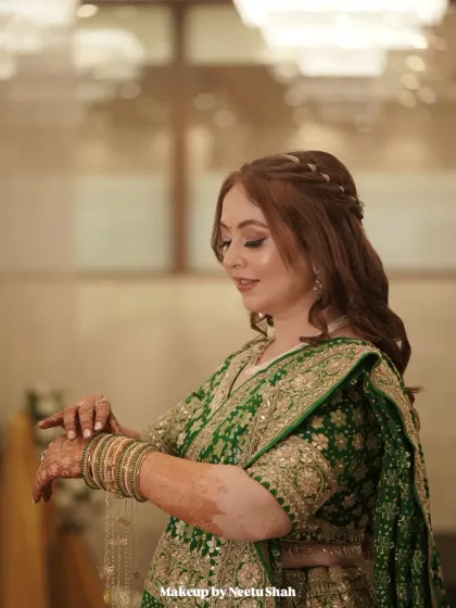 A quiet moment of reflection. The side profile highlights her soft curls and the flawless, skin-like finish of the makeup.