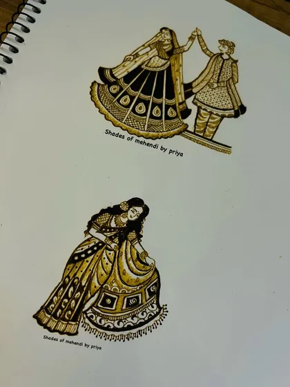 A page from my practice book showing different bridal figures. We practice various poses, like a dancing couple and a bride in a lehenga, to master movement and clothing details.