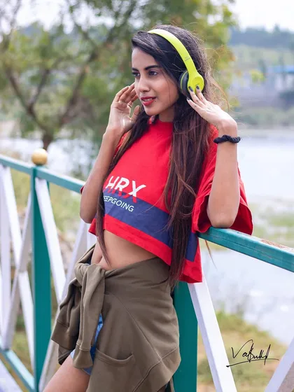 Music gives life to everything. This shot captures a happy, relaxed moment by the water, showing how we can incorporate personal interests like music into a fun and vibrant lifestyle photoshoot.
