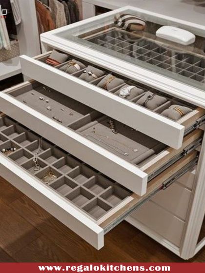 This custom island features tiered drawers with glass tops and specialized compartments for jewelry and watches, turning your accessory collection into a stunning display.