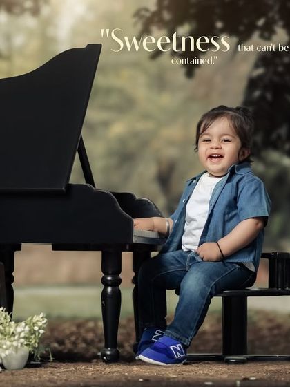 Sweetness that can't be contained. A happy boy in a denim shirt plays the piano in the park.