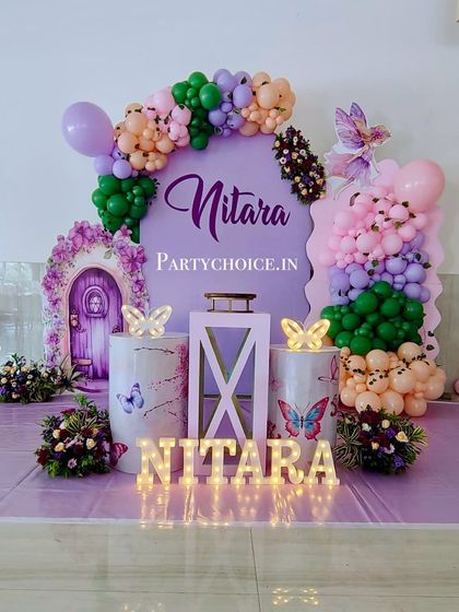 A closer look at the fairy-themed stage, with its magical door and butterfly-adorned pedestals.