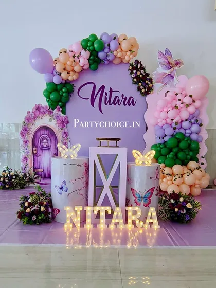 A clear shot of the fairy-themed stage, with its whimsical props, marquee letters, and colorful balloon arrangements.