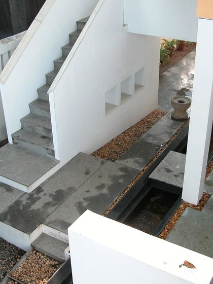 The interplay of levels, stairs, and water features at the Stuber Hall project. Our design creates a journey through the space, with intersecting planes of concrete and water guiding movement and creating moments of pause.