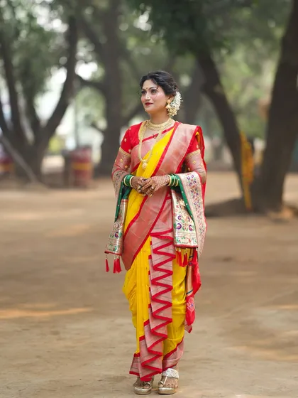 A full-length shot showcasing the unique zig-zag border of the Nauvari drape, a detail that adds to the authenticity of this Peshwai look.