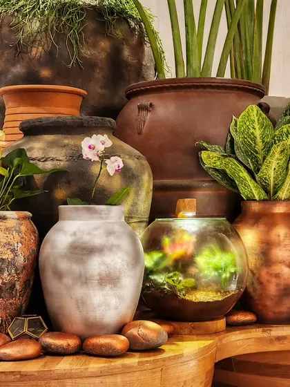 Happy Diwali from us to you! This beautiful arrangement showcases a variety of our products, from rustic pots and a glowing Living Lamp terrarium to delicate orchids. It’s a perfect festive display.