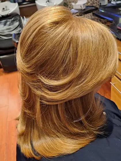 This look features significant volume at the crown and perfectly shaped ends, a signature of a professional salon blowout.