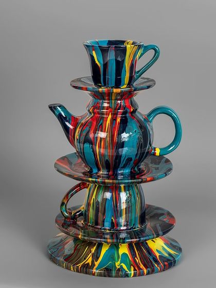 Another take on the whimsical stacked teacup theme, this sculpture uses a different color palette of deep blues, reds, and yellows. It’s a perfect piece of kitsch decor to brighten up any space.