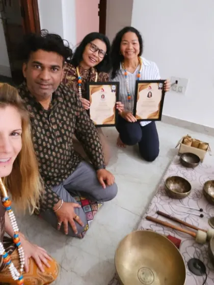 A selfie captures the happy and proud moment of graduation for this group of sound healing students.