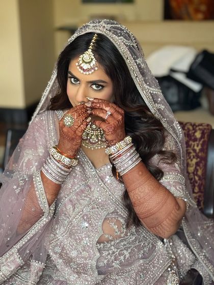 Another angle of the bride, showing the details of her nath and maang tikka.