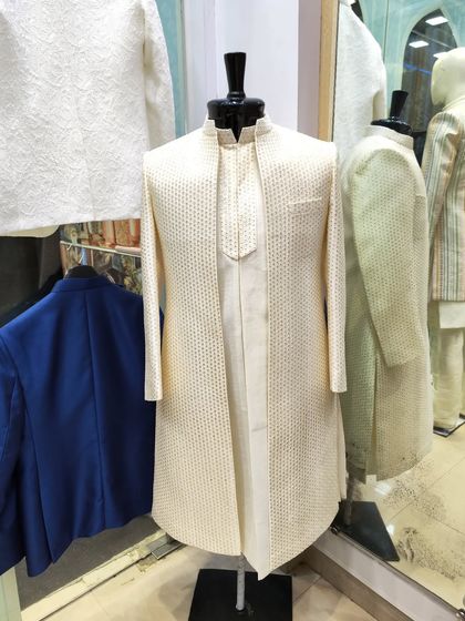 Another angle of the cream open sherwani-jacket, showing its clean lines and how it can be layered over a matching kurta.