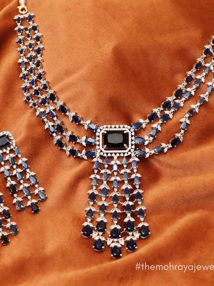 A beautiful three-layered necklace with blue sapphires and American diamonds. This piece is perfect for a royal-themed cocktail party or reception.