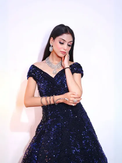 A close-up beauty shot that highlights the flawless makeup and the sparkle of the gown.