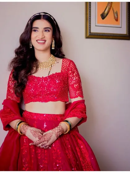 Simple, elegant, timeless. Aditi's reception look in a stunning red lehenga is a perfect example of modern bridal beauty.