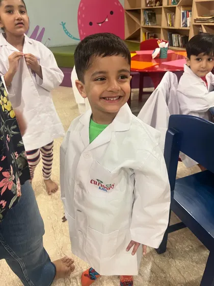 Look at that proud smile! Our little scientists love dressing up in lab coats for our hands-on STEM workshops, where they feel like real inventors.
