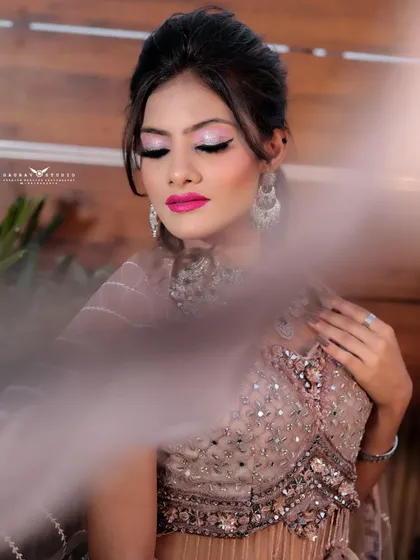 An artistic shot with a soft-focus effect in the foreground, drawing the viewer's eye to the model's face.