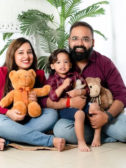 Today's beautiful moments are tomorrow's treasured memories. This happy family of three, surrounded by teddy bears, creates a warm and loving portrait.