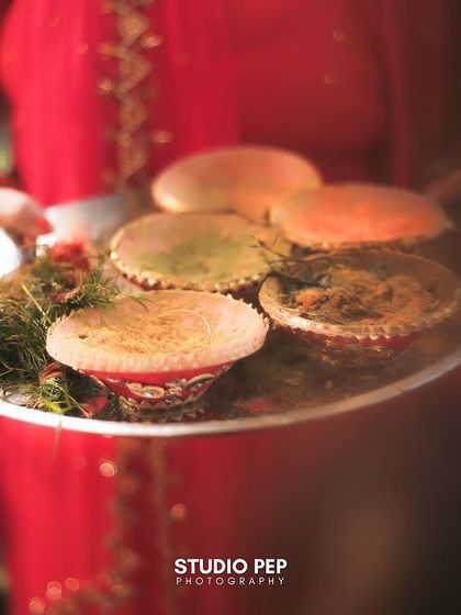 A detail shot of the Haldi platter, filled with colorful pastes and flowers, an essential element of the vibrant ceremony.