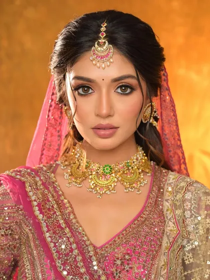 A close-up portrait that captures the stunning eye makeup and the flawless, glowing skin.