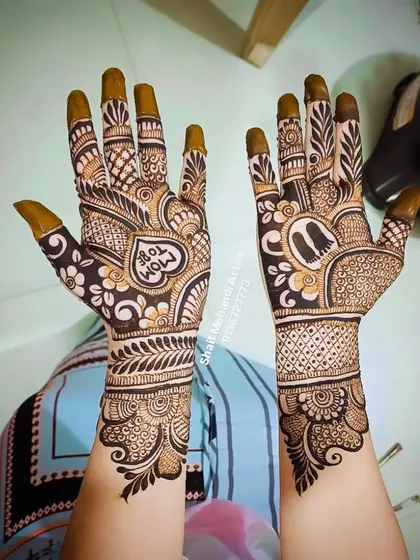 A view of the "Mom To Be" design held up, showcasing the full extent of the artwork from the palms to the mid-forearm.