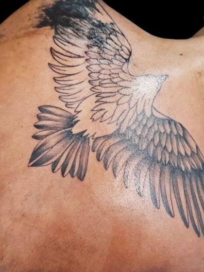 A side view of a large eagle tattoo, showing how the wings wrap from the back to the shoulder.