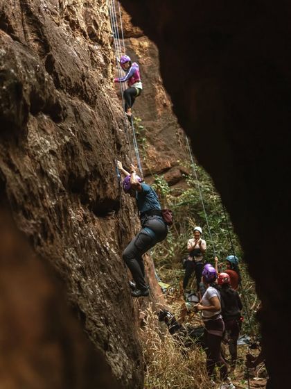A view from the side shows the impressive overhangs and vertical faces of the Badami cliffs, with our climbers tackling the challenge head-on.
