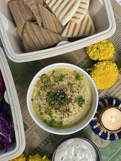 Another angle of our delicious hummus, showing its smooth texture. It's perfect for dipping with our warm pita bread.