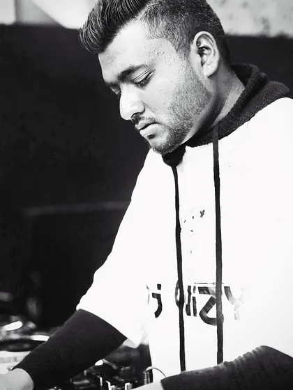A portrait of me locked into the music. My DJ mentorship is built on a foundation of deep love for the craft, which I aim to share with every student.