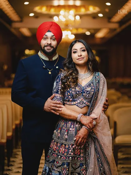 A classic portrait of the engaged couple. Their elegant blue outfits and confident poses make for a stunning photograph.