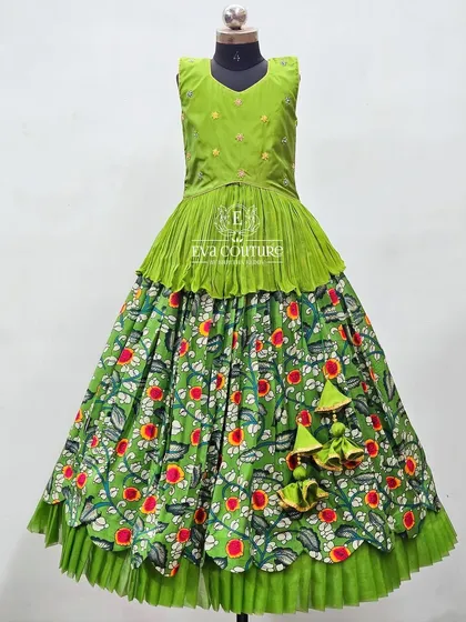 A full view of the green Kalamkari lehenga, showing the layered skirt and pleated peplum top.