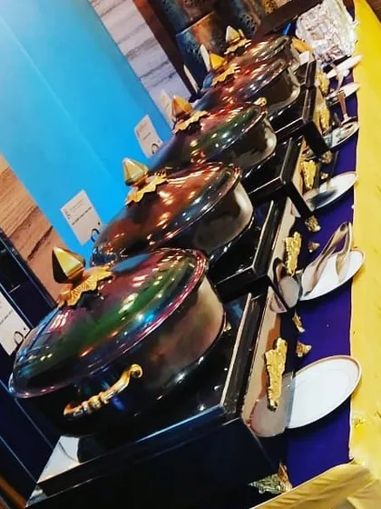 A close up of my unique, iridescent chafing dishes used for a Ganesh Chaturthi celebration. I invest in premium equipment to make your buffet stand out.