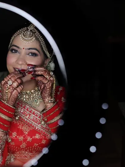 A stunning mirror shot of the bride, her smile as radiant as her mehendi. It's moments like these that make my work so rewarding.
