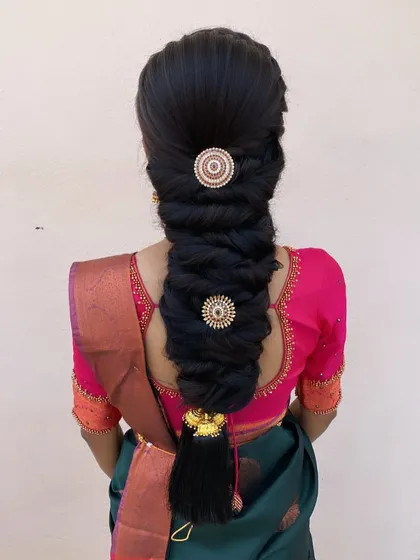 A unique and intricate braid style, decorated with pearl-studded discs. This is a beautiful and modern choice for a bride who wants something different.