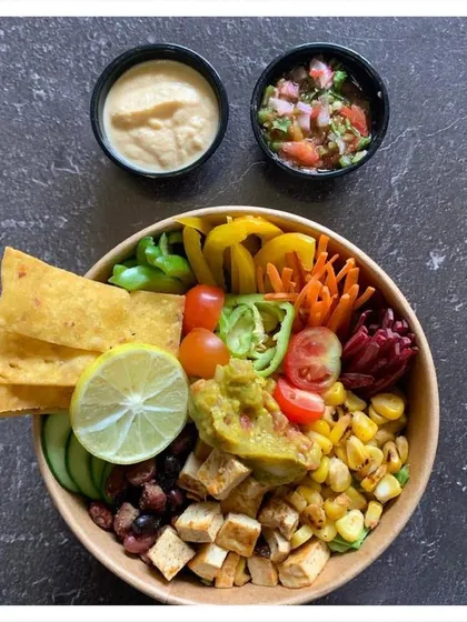 The Mexican Fiesta Salad Bowl is like a healthy plate of nachos. We combine chargrilled corn, black beans, and spiced tofu with fresh vegetables, and serve it with our own vegan cauliflower cheese sauce and pico de gallo.