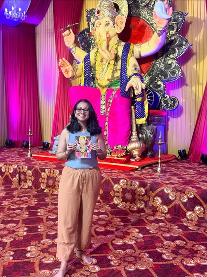 Another pose with my artwork and the beautiful Bappa idol. The scale and artistry of these public pandals are a huge source of inspiration for local artists.