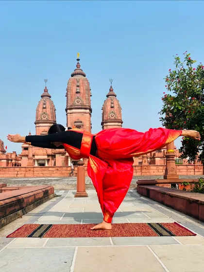 Virabhadrasana III (Warrior III) in front of the temple spires. This pose requires immense focus and strength, reminding us of the power we hold within.
