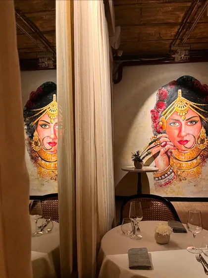 A striking mural of a royal Indian bride serves as a captivating focal point in one of our dining sections. It adds a touch of artistic soulfulness to the space.