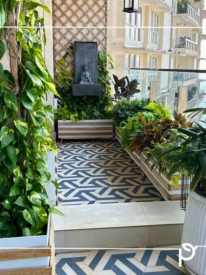 Even a compact city balcony can become a lush, private oasis. We transformed this space with a vertical green wall, custom planters, and a mix of foliage and flowering plants, creating a perfect corner for relaxation with a stunning view.