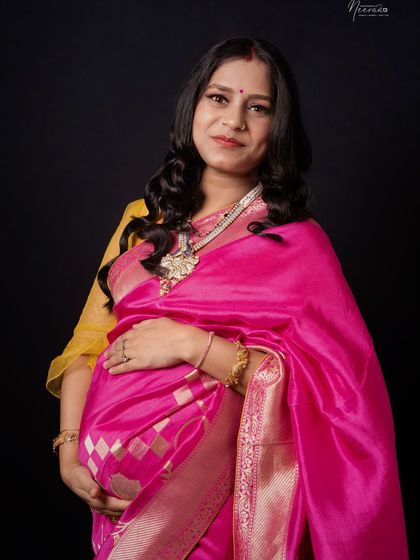 A close-up portrait that highlights her beautiful smile and the rich details of her saree and traditional jewelry. She looks absolutely radiant.