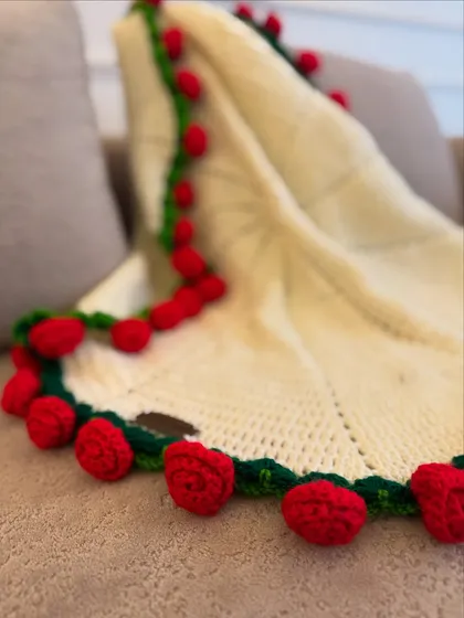 A detailed shot of the hand-crocheted roses that form the edge of our popular bouquet blanket.