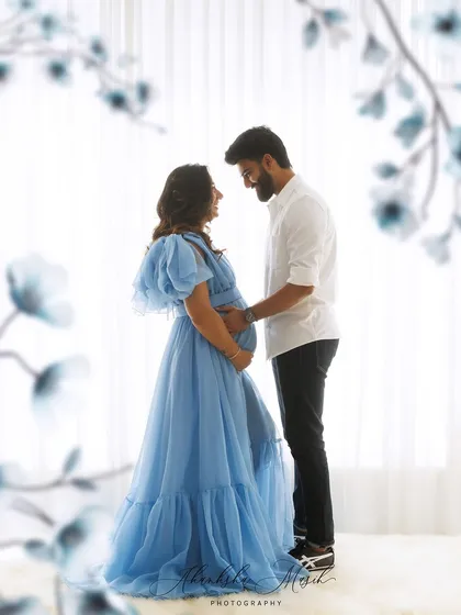 Awaiting a new beginning in a loving embrace. This ethereal maternity portrait captures the quiet, intimate connection between partners during this beautiful journey.