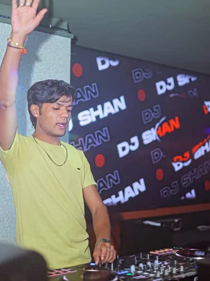 Waving to the crowd while keeping the beats flowing. It's all about interaction and energy.