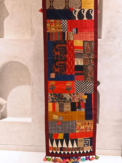 A 100% scrap throw in warm, autumnal colors, designed as a long runner. It's pieced together from the odds and ends of a hundred other projects, each scrap holding a memory.