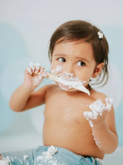 A wider angle of the action, showing him using a wooden spoon to dig in. Using props like this can lead to some very cute interactions.